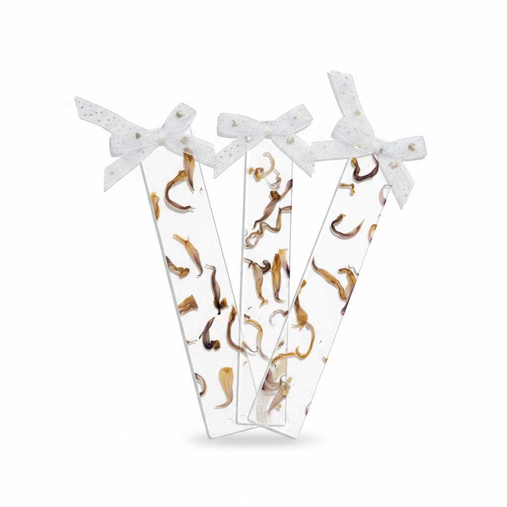 The J.M Press clear bookmarks with pressed dried flowers and white ribbon bows.