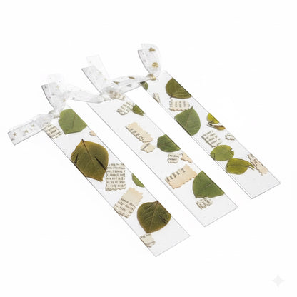 The J.M Press clear bookmarks with pressed green leaves and vintage text fragments, tied with sheer ribbon.