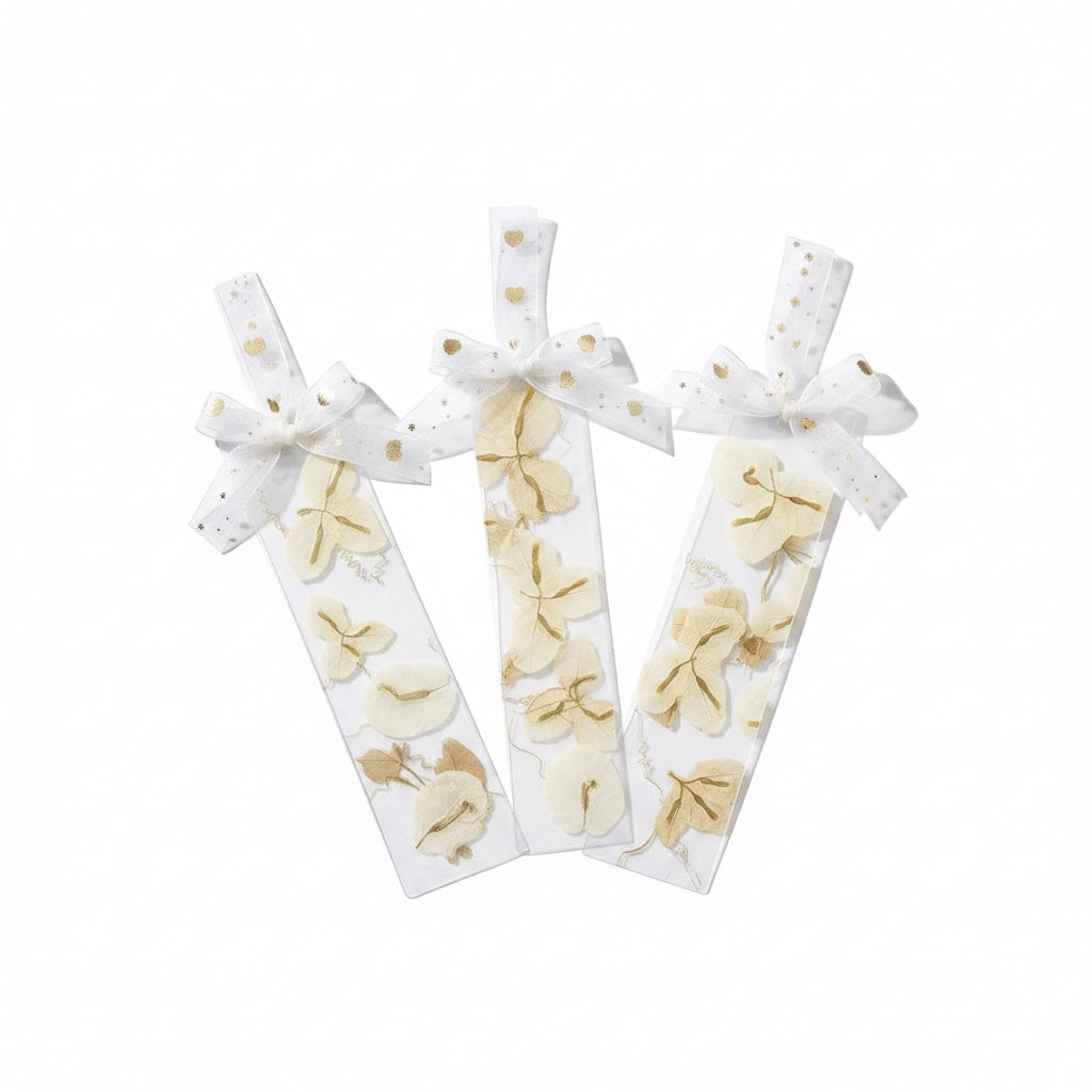 The J.M Press white bookmarks with pressed beige flowers and gold heart ribbon.