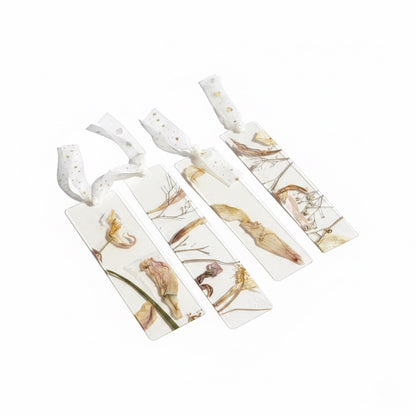 The J.M Press Silvered Forest Trio bookmarks featuring dried flowers and leaves encased in clear resin with white ribbon ties.