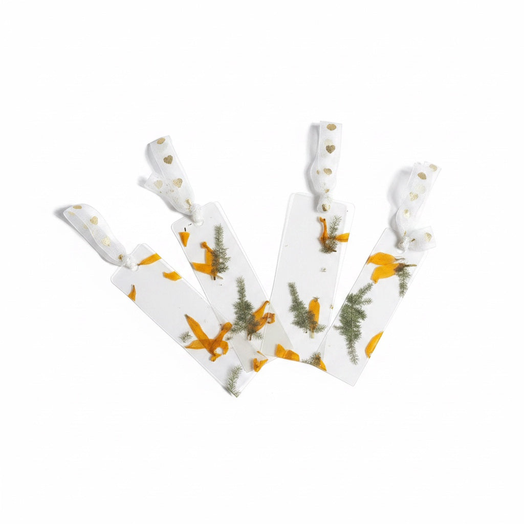 The J.M Press clear bookmarks with pressed yellow flowers and green foliage, tied with gold-dotted ribbon.
