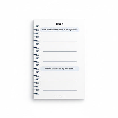 The J.M Press Affirmed In Business Pocket Diary Volume One, a white spiral-bound journal with prompts for defining success.