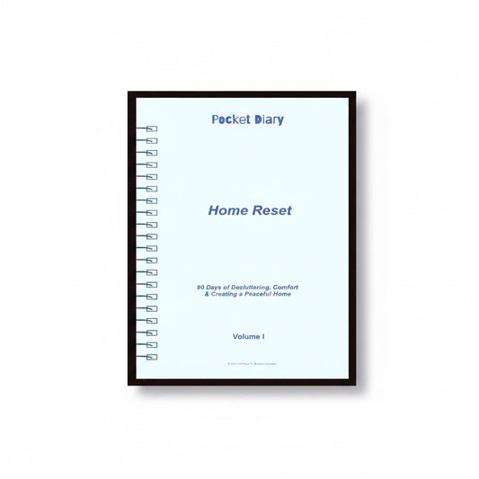 The J.M Press Home Reset Pocket Diary, a light blue journal with spiral binding, guides users through 90 days of decluttering and creating a peaceful home.